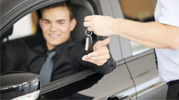 handing car keys to a driver