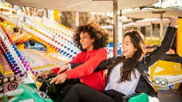 thumbnail image of two women on an amusement park ride