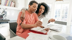 two adults reviewing receipts together