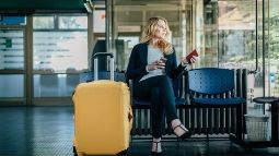 woman with suitcase waiting for flight