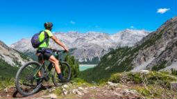 person on bicycle with mountain landscape