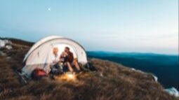 senior couple camping on mountainside