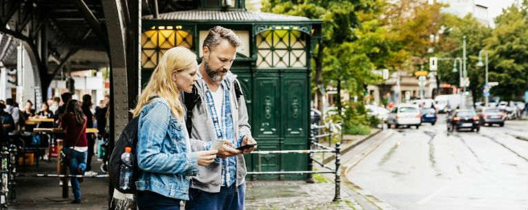 Allianz - couple looking up directions on smartphone