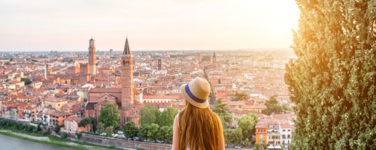 Allianz - Woman enjoying beautiful sunset view on Verona city in Italy