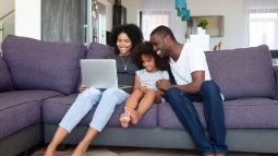 family on couch with laptop