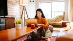 woman at table with laptop