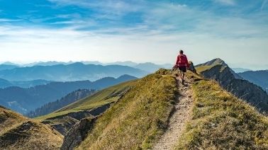 Allianz - traveler hiking on mountain