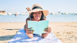 traveler reading on the beach