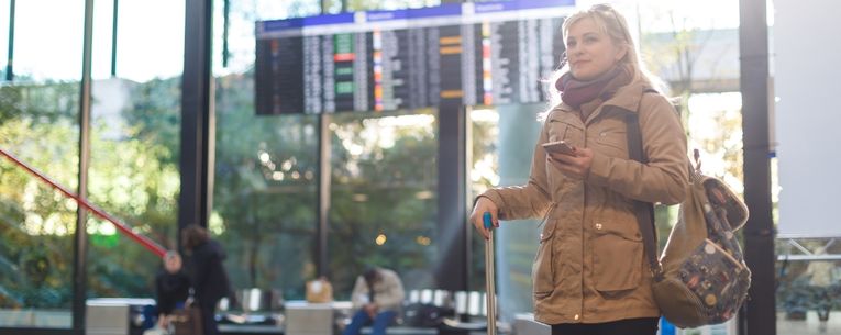Allianz - woman standing in airport with phone