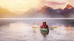 couple kayaking on romantic mountain lake