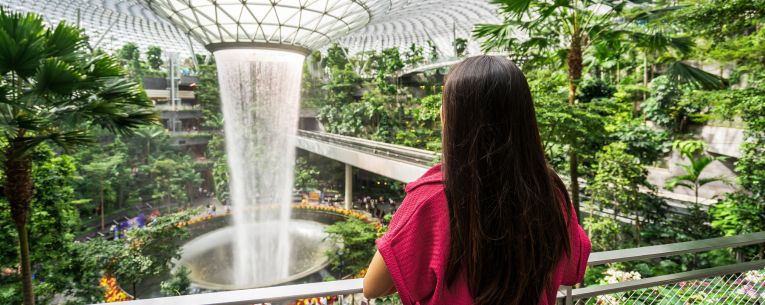 Allianz - woman watching indoor waterfall in Changi Airport, Singapore