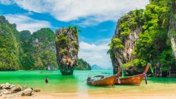 traveler with boats in Phang-Nga bay in Thailand