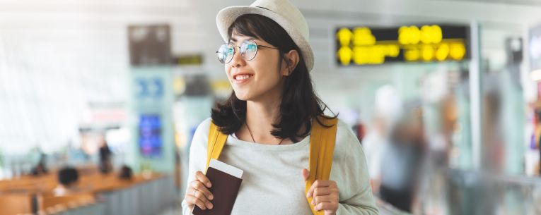 Allianz - woman with passport in airport