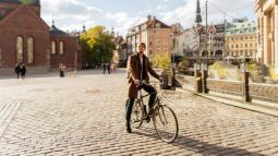 man traveling city on a bicycle