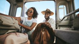 travelers packing car for a trip