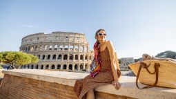woman sitting in front of the coliseum