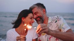 couple celebrating fourth of july with sparklers