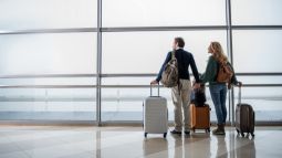 travelers with luggage in airport